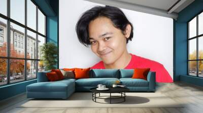 Portrait of a longish, handsome Indonesian man wearing plain red clothes with random expressions isolated on white background Wall mural