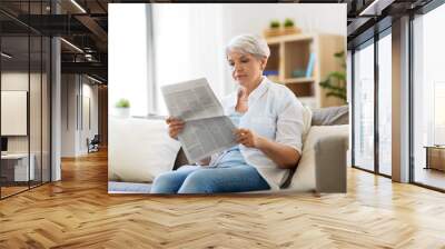 age and people concept - senior woman reading newspaper at home Wall mural