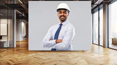 architecture, construction business and building - smiling indian architect or businessman in helmet over grey background Wall mural