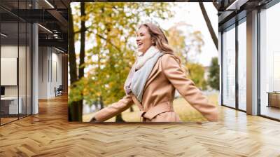 beautiful happy young woman walking in autumn park Wall mural