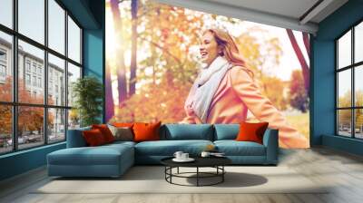 beautiful happy young woman walking in autumn park Wall mural