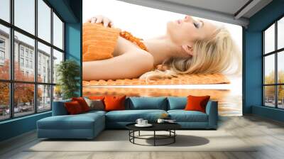 beautiful lady with orange towels in spa salon Wall mural