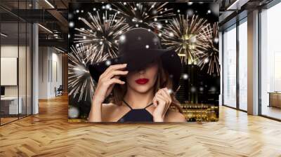 beautiful woman in black hat over night firework Wall mural