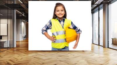 building, construction and profession concept - smiling little girl with protective helmet and safety vest over white background Wall mural