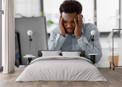 business, people, deadline and technology concept - stressed african american businessman with papers and computer working computer at office Wall mural