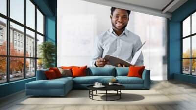 business, people and corporate concept - smiling african american businessman with folder at office Wall mural