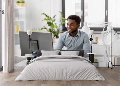 business, people and technology concept - african american businessman with computer working at offi Wall mural