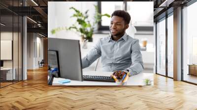 business, people and technology concept - african american businessman with computer working at offi Wall mural