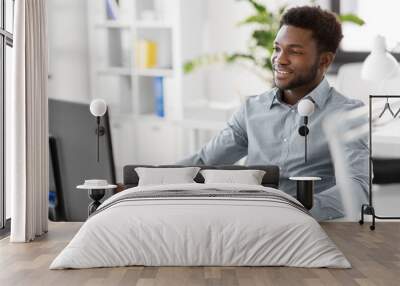 business, people and technology concept - african american businessman with computer working at office Wall mural