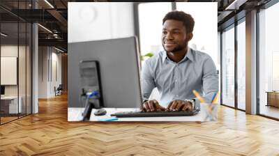 business, people and technology concept - african american businessman with computer working at office Wall mural