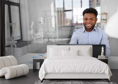 business, people and technology concept - african american businessman with laptop computer working at office Wall mural