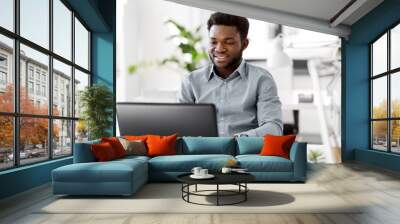 business, people and technology concept - african american businessman with laptop computer working at office Wall mural