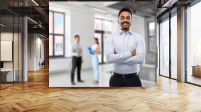 business, realty and people concept - smiling indian businessman or realtor over empty office room background Wall mural