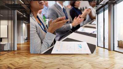 business and education concept - group of happy people applauding at international conference Wall mural