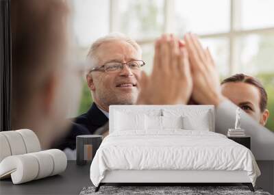 business people making high five in office Wall mural