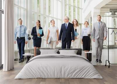 business people walking along office building Wall mural