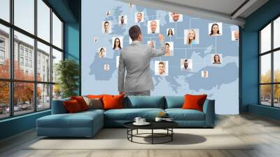 businessman at virtual screen with contacts Wall mural