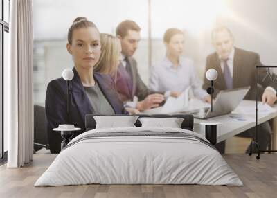 businesswoman in office with team on the back Wall mural