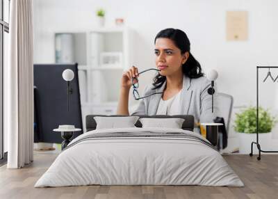 businesswoman with glasses and computer at office Wall mural