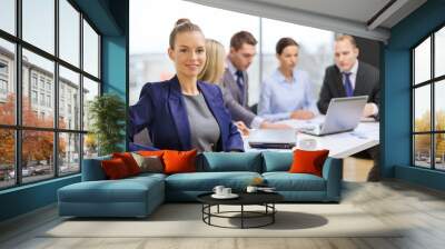 businesswoman with glasses with team on the back Wall mural