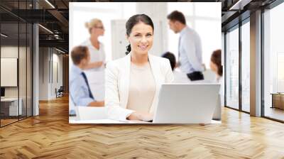 businesswoman with laptop computer at work Wall mural