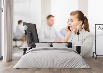 businesswoman with smartphone in office Wall mural