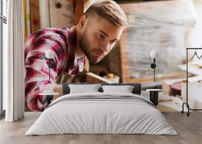 carpenter working with wood plank at workshop Wall mural