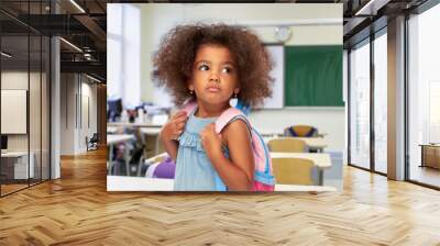 childhood, school and education concept - sad little african american girl with backpack over classroom on background Wall mural