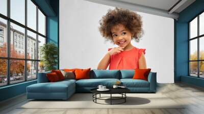 childhood and people concept - happy little african american girl over grey background Wall mural