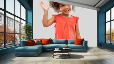 childhood and people concept - happy little african american girl waving hand over grey background Wall mural