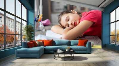 children, education and learning concept - tired teenage student girl sleeping on table at home Wall mural