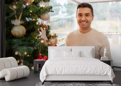 christmas, people and holidays concept - happy smiling middle aged man with gift box at home Wall mural