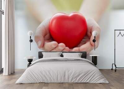 close up of child hands holding red heart Wall mural