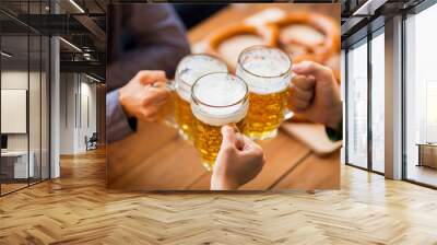 close up of hands with beer mugs at bar or pub Wall mural