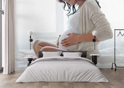 close up of happy pregnant woman in bed at home Wall mural