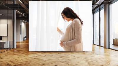 close up of happy pregnant woman with big belly Wall mural