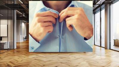 close up of man in shirt dressing  Wall mural