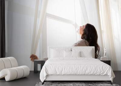 close up of pregnant woman opening window curtains Wall mural