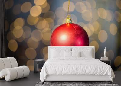 close up of red christmas ball over golden lights Wall mural