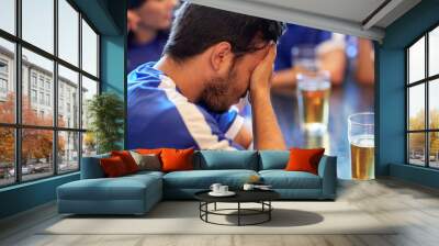 close up of sad football fan at bar or pub Wall mural