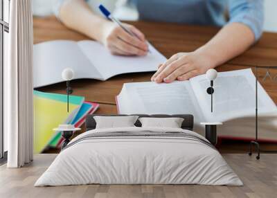 close up of student with book and notebook at home Wall mural