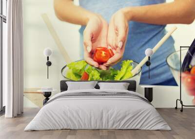 close up of woman cooking vegetable salad at home Wall mural