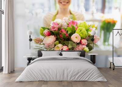 close up of woman holding bunch at flower shop Wall mural