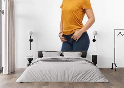 clothes and people concept - smiling young woman or teenage girl in orange t-shirt and jeans over white background Wall mural