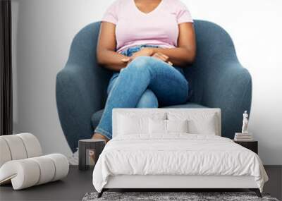 comfort, people and furniture concept - portrait of happy smiling young african american woman sitting in modern armchair over white background Wall mural