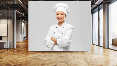 cooking, culinary and people concept - happy smiling female chef in white jacket over grey background Wall mural