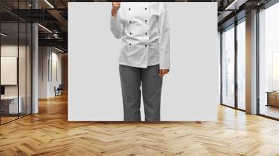 cooking, culinary and people concept - happy smiling female chef in white toque and jacket with kitchen knife over grey background Wall mural