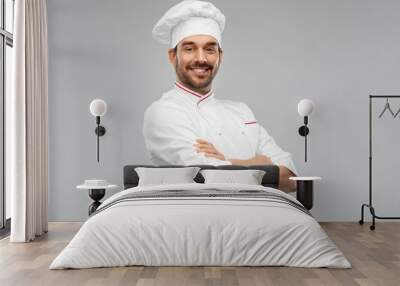 cooking, culinary and people concept - happy smiling male chef in toque and jacket over grey background Wall mural