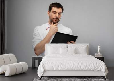 cooking, culinary and people concept - thinking male chef with tablet pc computer over grey background Wall mural