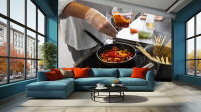 cooking food, profession and people concept - close up of male chef with frying pan stewing vegetables at restaurant kitchen Wall mural